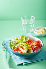 healthy vegan avocado salad with tomatoes and sweetcorn