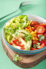 healthy vegan avocado salad with tomatoes and sweetcorn