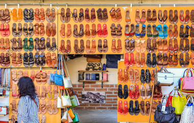 Fototapeta na wymiar A wall of leather sandals on display at the San Lorenzo market in Florence, Italy
