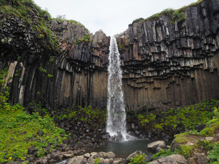 waterfall in Iceland, with columnar basalt