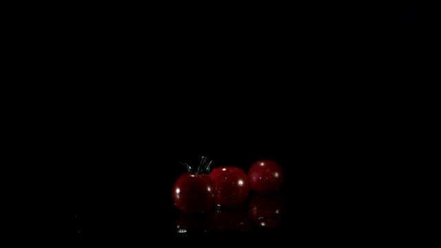 Tomato falls down on the table and spins around.