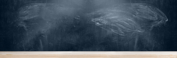 School blackboard with wooden table background