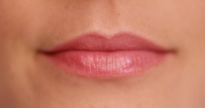 Woman asking for a kiss pursing her lips in a sexy seductive gesture, close up view of her mouth