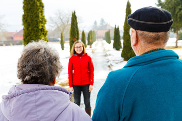 Elderly couple and young caregiver