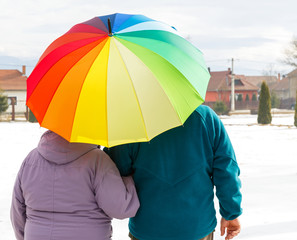 Elderly couple with colorful umbrella