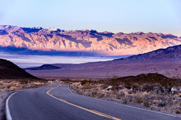 Desert road in Death Valley with mountain background