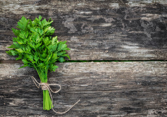 a bunch of parsley on wooden background
