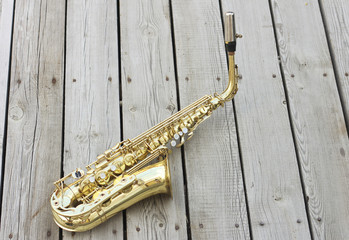Saxophone on a wooden background.Golden saxophone. Soprano Saxophone.Wind musical instrument