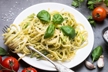 Pasta spaghetti with zucchini basil and cheese.