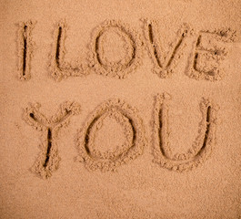 I Love You written in soft wet sand on a beach