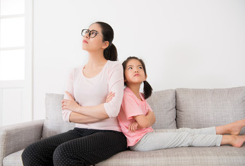 beautiful mother and daughter sitting together