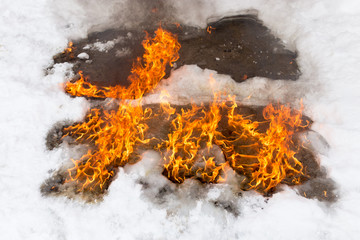 fiery flame on the white snow in winter