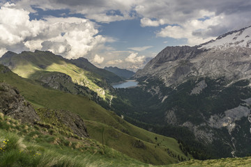 Fototapeta na wymiar Lago di Fedaia and Marmolada massif in the beautiful landscape of the Dolomites. Italy.