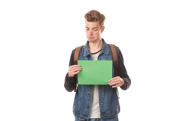 Portrait of schoolboy posing with blank paper against white background