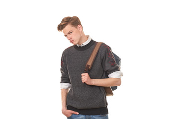 Fototapeta premium Studio portrait of handsome college boy in casual clothing with backpack