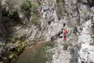 mountaineer in front of a river checking the GPS