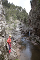 Fototapeta premium mountaineer in front of a river with waterfall