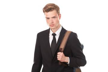 Studio portrait of teenage college student in black suit posing against white background