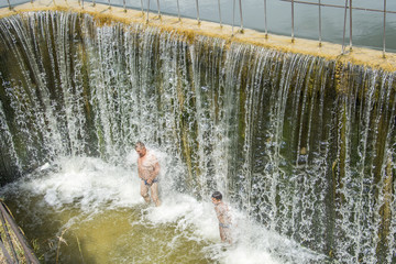 Waterfall. In the summer on the dam people swim under the streams of water.
