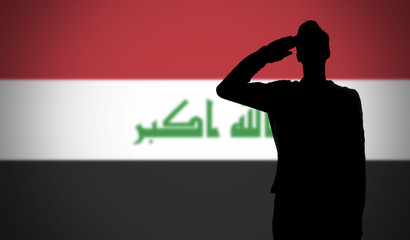 Silhouette of a soldier saluting against the iraq flag