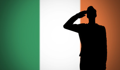 Silhouette of a soldier saluting against the ireland flag