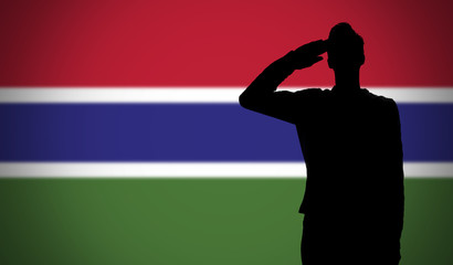 Silhouette of a soldier saluting against the gambia flag