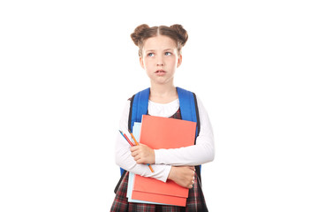 Portrait of girl in school uniform with backpack holding textbooks and pencils and thinking sadly against white background