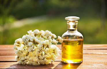 Aromatic essential oil and white flowers. Spa concept. Cosmetics and spa care.