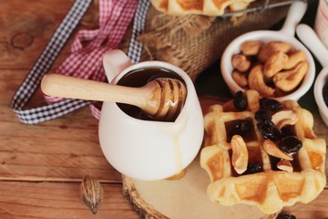 Waffles topped with honey, raisins and cashews.