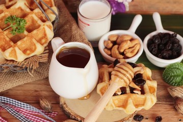 Waffles topped with honey, raisins and cashews.