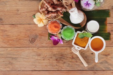 Turmeric root with turmeric powder on wood background