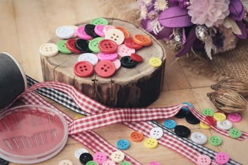Colorful thread for sewing on wood background