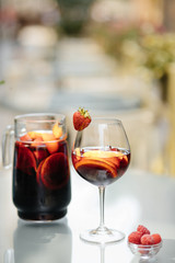 Summer drink Sangria with orange and cranberry. Selective focus. Copy space