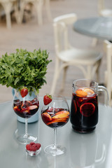 Summer drink Sangria with orange and cranberry. Selective focus. Copy space