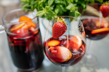 Summer drink Sangria with orange and cranberry. Selective focus. Copy space