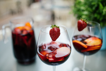 Summer drink Sangria with orange and cranberry. Selective focus. Copy space