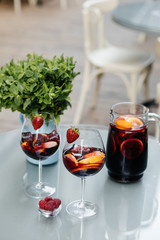 Summer drink Sangria with orange and cranberry. Selective focus. Copy space