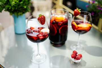 Summer drink Sangria with orange and cranberry. Selective focus. Copy space