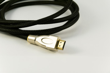 Black audio video HDMI computer cable isolated on white background.