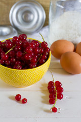 Red currants in the jar. Gray background.