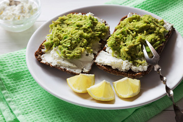 Avocado sandwiches with cottage cheese close up