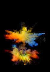 Multi cloud blasting  powder paint and flour combined, explode in front of a black background to give off fantastic multi color forms.
