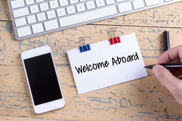 Paper note with text Welcome Aboard