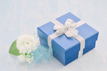 blue gift box with silver ribbon bow and Jasmine flower