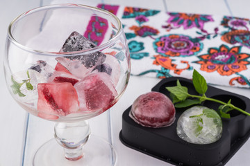 Different shapes of ice with berries.