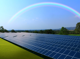 Solar panels with rainbow sky, Solar power plant with beautiful rainbow background