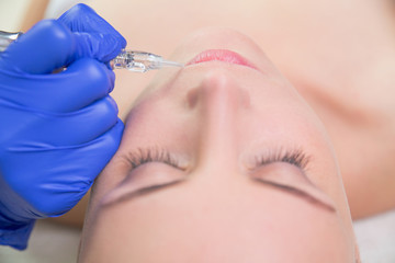 Closeup of beautiful woman face with botox and syringe