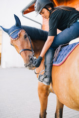 Beautiful brunette girl riding her horse. 