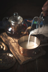 Cooking chocolate vegetarian truffles on the wooden table