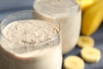 Fresh tasty smoothie in glass on table, closeup